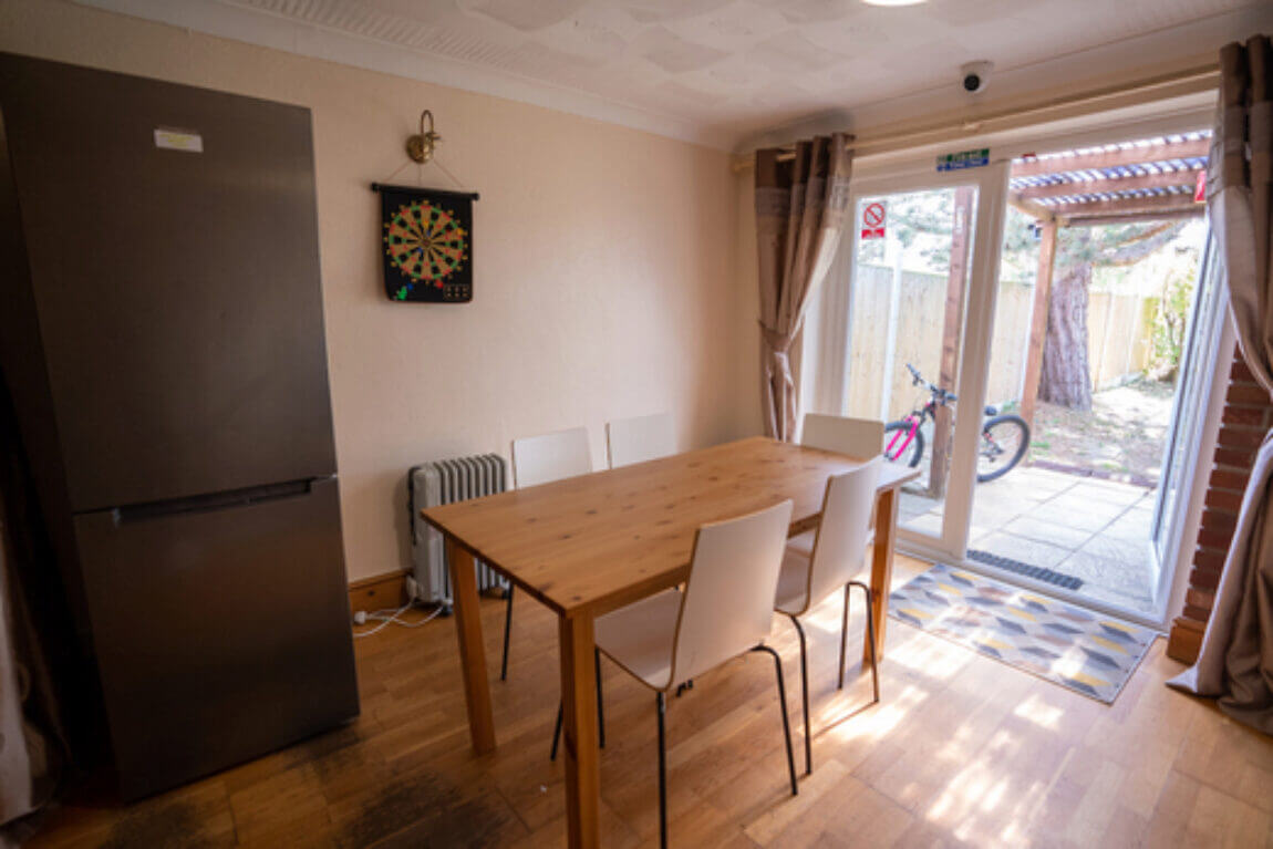 Dining area with fridge and dartboard
